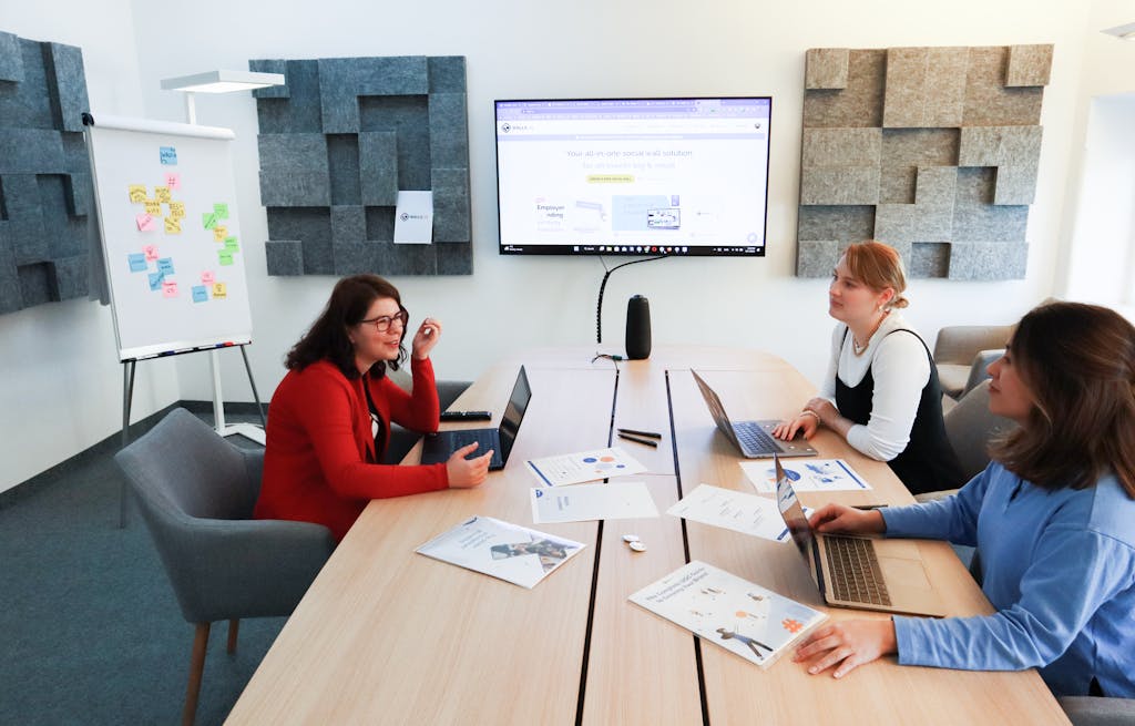 Women having a marketing meeting in a meeting room with a screen